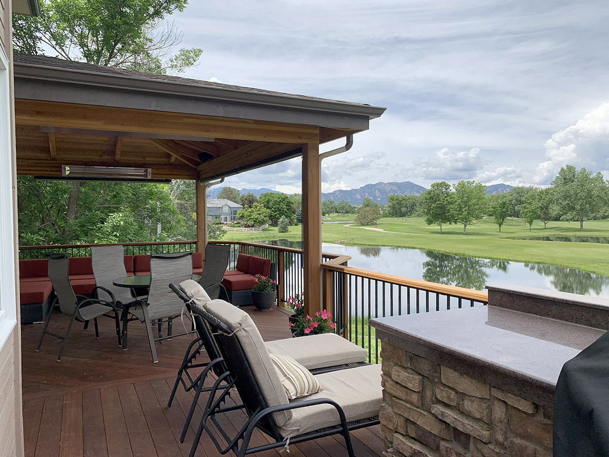 stained wood deck with a roof cover with a beautiful view