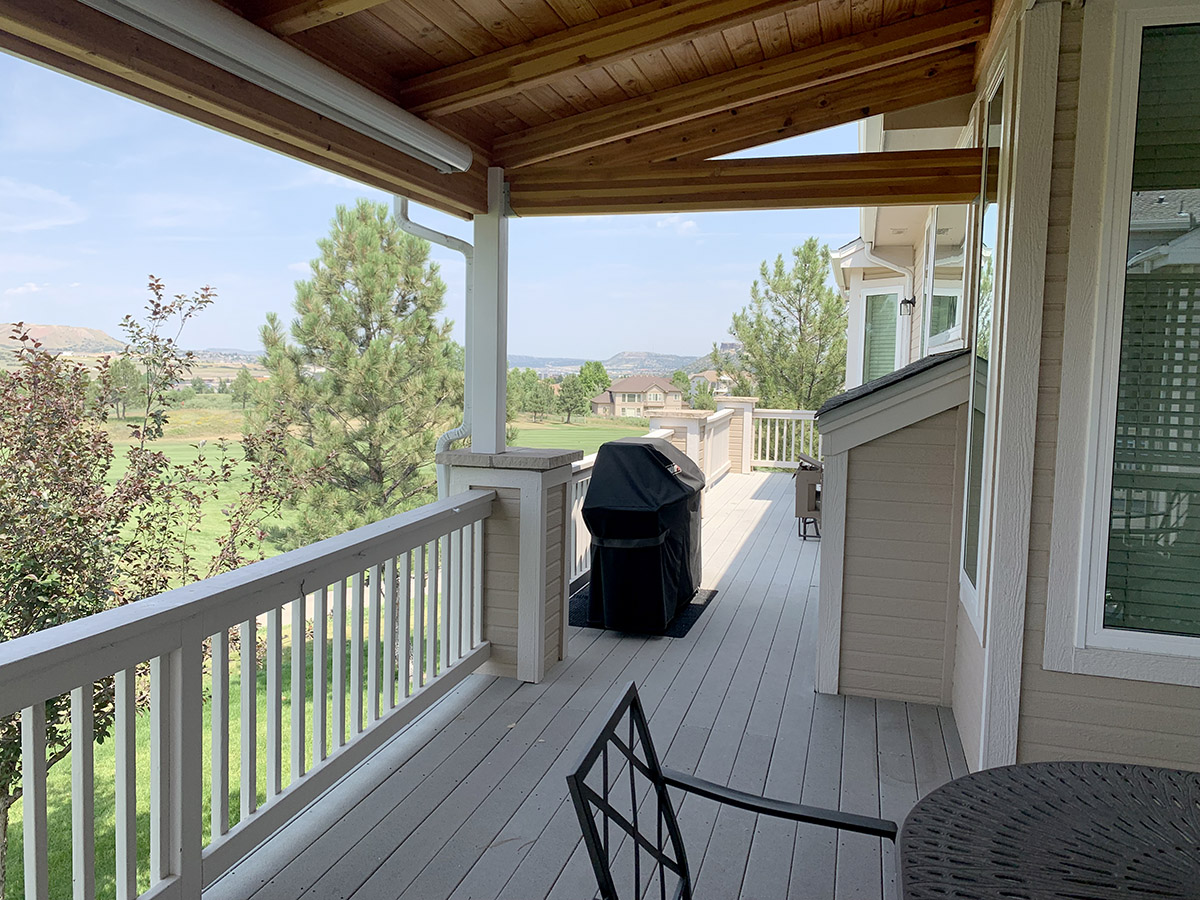 a long elevated deck with a roof cover over half