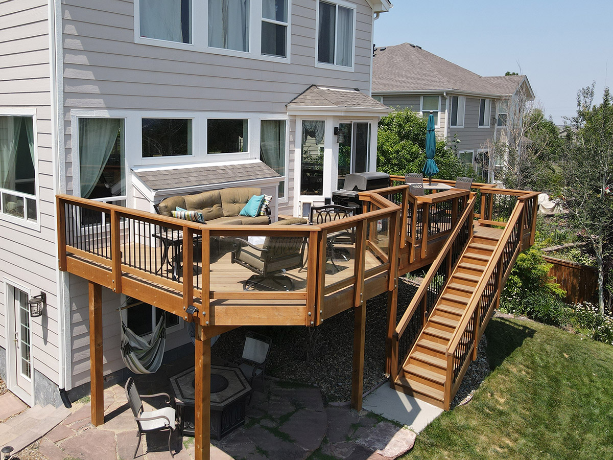 second story custom tiered deck with a custom staircase